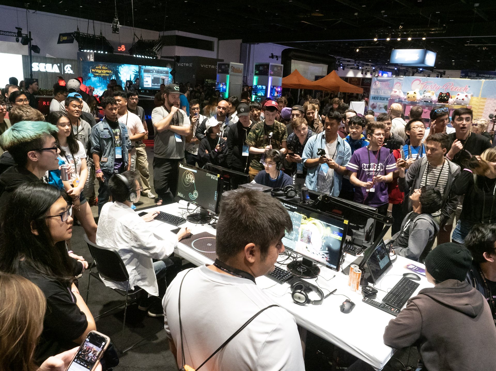 Gaming creators and fans gather at a TwitchCon booth.
